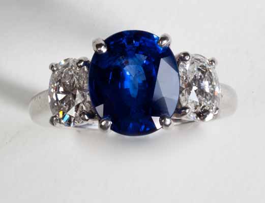  GIA certified Ceylon origin blue sapphire in platinum, with two oval shape diamonds (half Carat each) on sides. Nobel Antique jewelry Store, Santa Monica. Made in America.